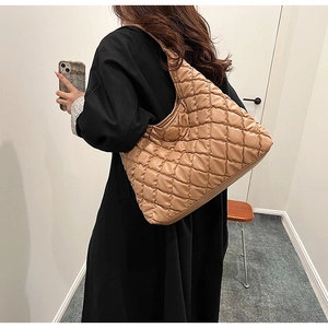 Quilted khaki tote bag shoulder view showing large capacity and puffy rhombic texture
