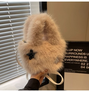 Detail of soft faux fur bucket bag with a black star accent and fine leather straps