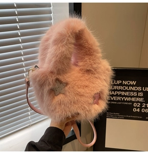 Detail of pink faux fur bucket bag with star patches and slim leather shoulder strap