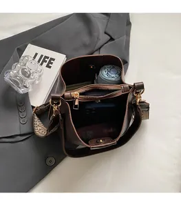 Interior view of brown leather bucket bag showing spacious storage for umbrella and phone