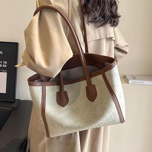 Large minimalist tote bag with contrast trim and long shoulder straps for daily commute