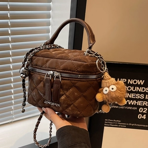 Brown quilted crossbody bucket bag with chain strap and star plush pendant