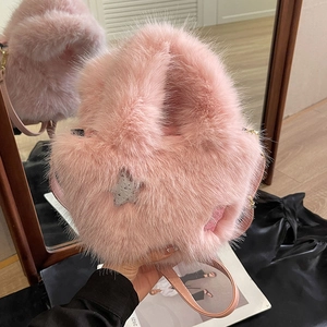Pink fluffy faux fur bucket bag with star sequins and a slim crossbody leather strap