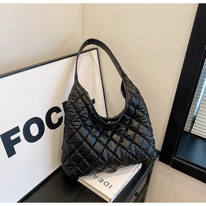 Detail of the black quilted rhombic pattern and soft cloud-like texture on the hobo tote bag