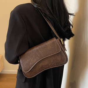Deep brown vintage leather underarm bag with asymmetrical flap and gold metal buckle