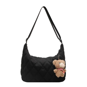 Black quilted nylon tote bag with adjustable strap and cute plush bear charm decoration