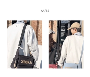 Detail view of XBOKA canvas messenger bag featuring wide adjustable strap and embroidery