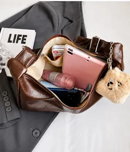 Spacious interior of brown faux leather hobo bag showing large storage and zip pocket