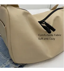 Detail of beige nylon pillow bag featuring a smooth zipper and woven cord puller