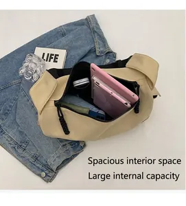 Top view of beige leather crossbody bag interior showing large capacity for tablets
