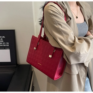 Side view of red textured leather wedding tote bag showing capacity and golden hardware