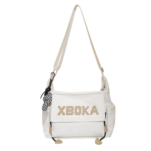 Minimalist beige canvas tote bag with XBOKA letter patch and checkered charm