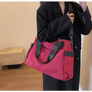 Détail de sac de voyage Oxford bordeaux montrant les ferrures argentées et le nylon