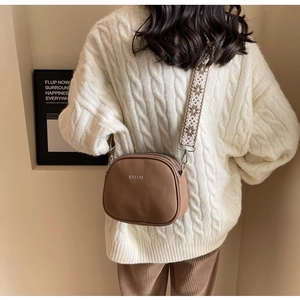 Brown leather crossbody bag detail featuring ethnic jacquard wide strap and double zipper