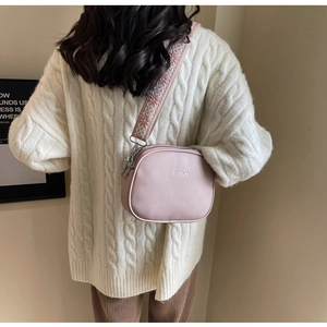 Pink lychee texture crossbody bag with wide embroidered jacquard strap detail