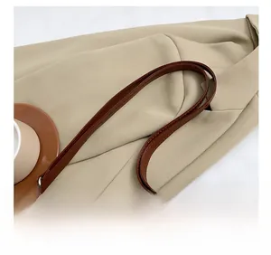 Close-up of comfortable leather shoulder strap with durable stitching and metal hardware
