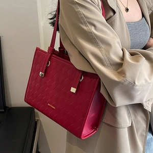 Red quilted leather tote bag with gold logo for weddings and daily use