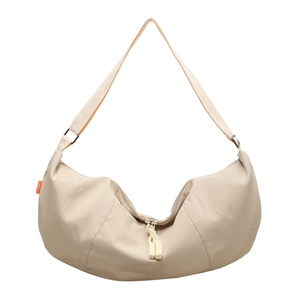 Minimalist beige nylon half-moon crossbody bag with woven zipper and adjustable strap