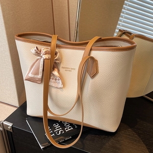 Minimalist cream tote bag with contrast brown trim and decorative silk scarf detail