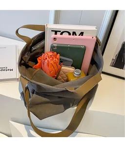 Spacious interior of canvas tote bag showing large capacity for books and tablet