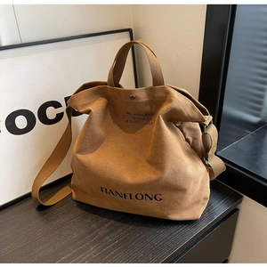 Detailed macro of vintage brown canvas tote bag texture with adjustable wide strap