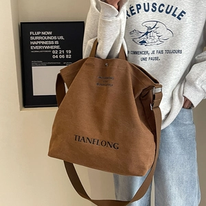 Brown large capacity canvas tote bag with black lettering and adjustable shoulder strap