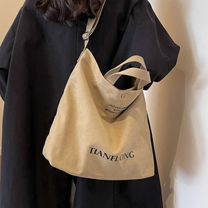 Large beige canvas tote bag with adjustable shoulder strap and print for women