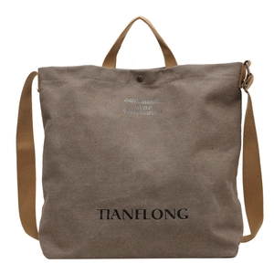 Large capacity dark brown canvas tote bag with adjustable strap for versatile shoulder use