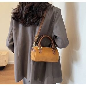 Close-up of brown frosted Boston bag showing matte texture and gold-tone hardware detail