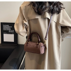 Brown frosted Boston bag shown on model for size perspective and retro style