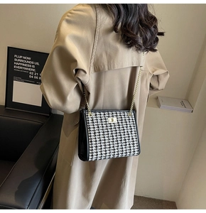 Classic houndstooth shoulder bag with gold twist lock shown on model for size and style