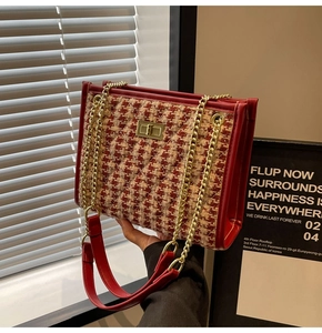 Close-up of red tweed bridal handbag with gold twist lock and elegant chain strap details