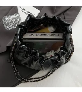 Interior view of black pleated shoulder bag showing spacious storage for iPad and books
