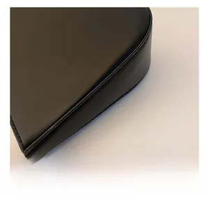 Detailed macro view of the black leather edge stitching and matte texture on underarm bag