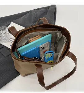 Interior view of large capacity color-block tote bag showing spacious storage for gadgets