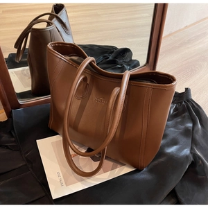 Detail of high-quality brown PU leather texture and Ballada logo on a large tote bag