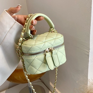 Chic mint green quilted mini bucket bag with gold chain strap and top handle