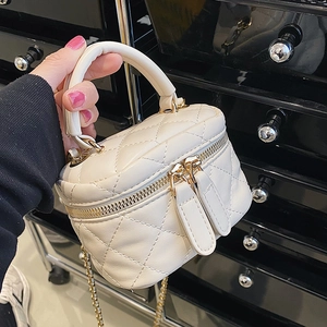 Quilted mini bucket bag in cream faux leather with gold chain strap and top handle