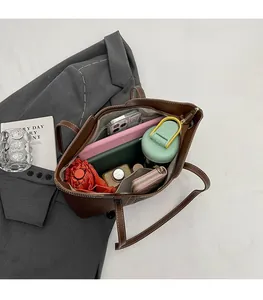 Spacious interior of a dark brown leather tote bag showcasing large storage capacity