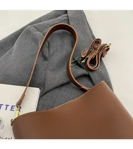 Detail view of brown matte leather shoulder bag with extra smooth long adjustable strap