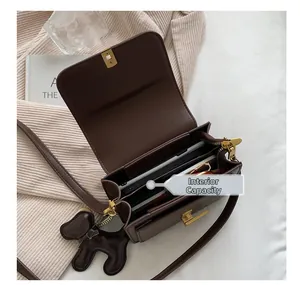 Internal capacity of dark brown leather crossbody bag with dividers and golden buckle