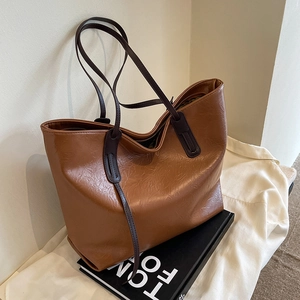 Brown vintage pleated leather tote bag with long tassels and shoulder straps for women
