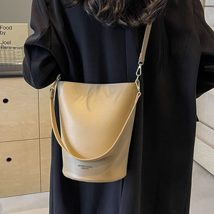 Chic beige leather bucket bag for women, versatile shoulder and crossbody style