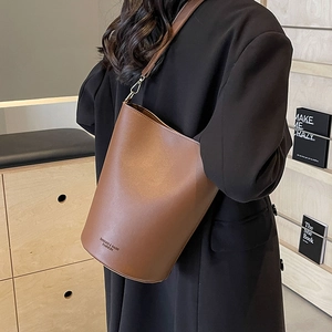 Large dark brown bucket bag in smooth leather with adjustable strap for women