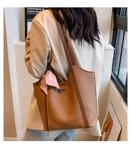 Deep brown oversized tote bag with lychee grain texture and a pink silk scarf accent