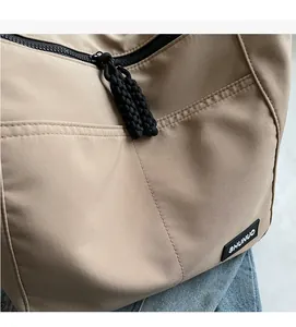 Detailed macro view of khaki nylon fabric texture and woven rope zipper puller
