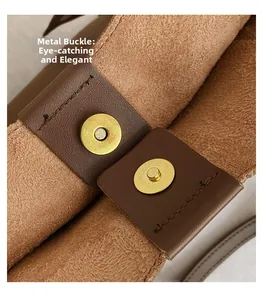 Macro view of golden magnetic clasps and textured leather interior on dark brown tote bag