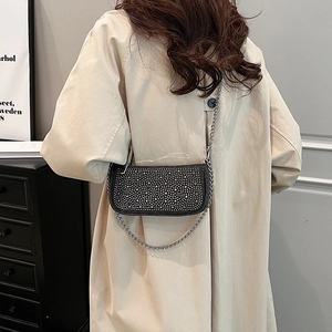 Sparkling rhinestone denim underarm bag with silver chain strap shown on a model