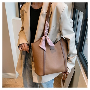 Brown litchi leather tote bag with elegant pink floral scarf detail on the shoulder strap