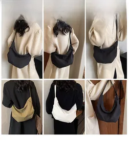 Three crescent crossbody bags in black, white, and khaki corduroy shown on models